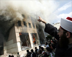 [ Muslims burn buildings related to Western interests in response to publication in a Danish newspaper of cartoons depicting the Prophet Mohammed... ]