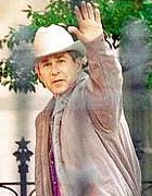 [ George W. Bush looking out of his cowboy hat ]